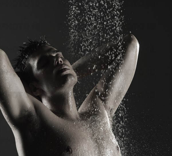 Caucasian man standing in shower