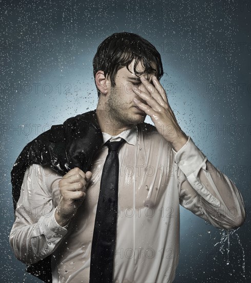 Caucasian businessman standing in the rain