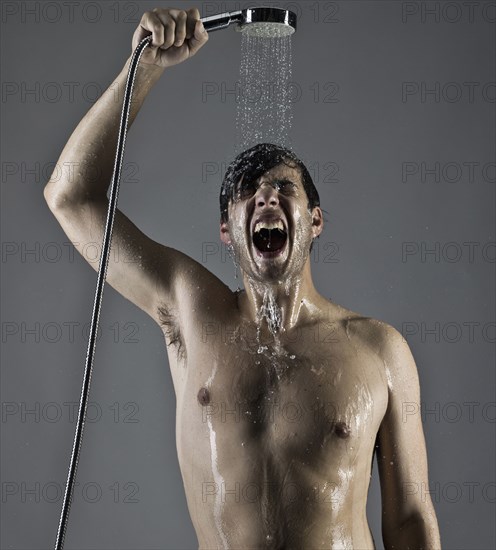 Caucasian man taking a shower