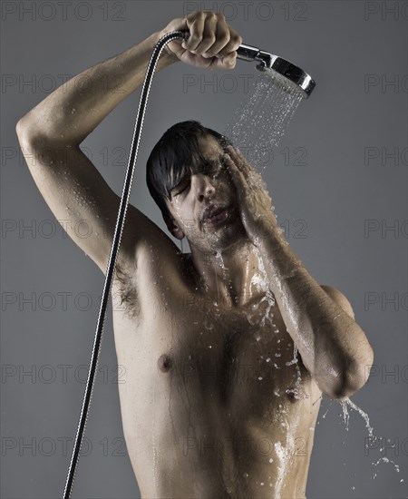 Caucasian man taking a shower