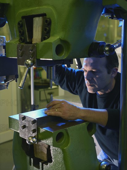 Caucasian worker using industrial drill