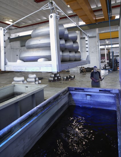 Caucasian worker working in steel factory