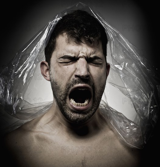 Man shouting with plastic on his head