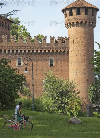 Caucasian couple looking at Italian tower