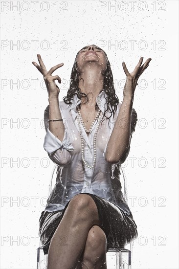 Rain falling on Caucasian businesswoman