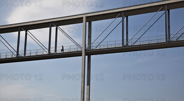 Woman walking on skybridge