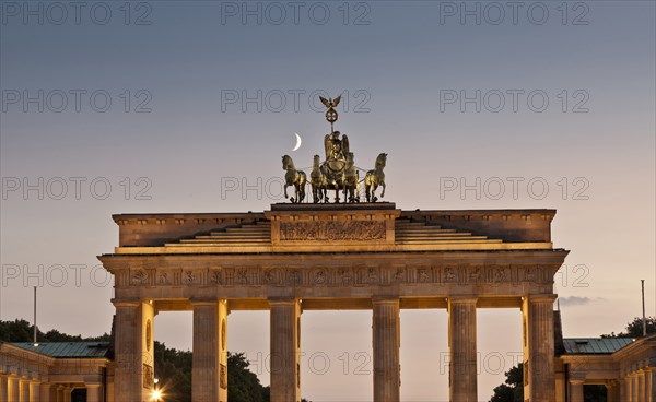 Columned building and statue lit up at night