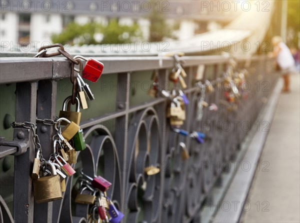 Close up of locks strung on urban bridge