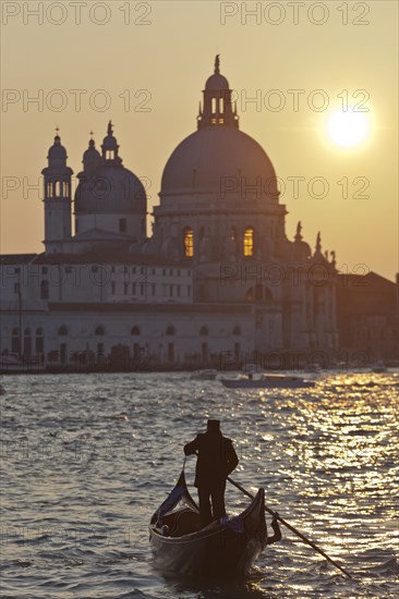 Man rowing gondola on canal