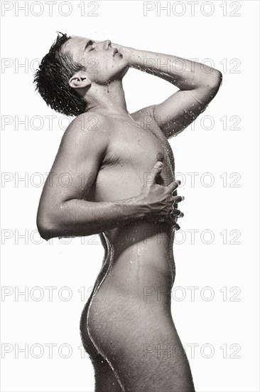 Caucasian man posing in shower