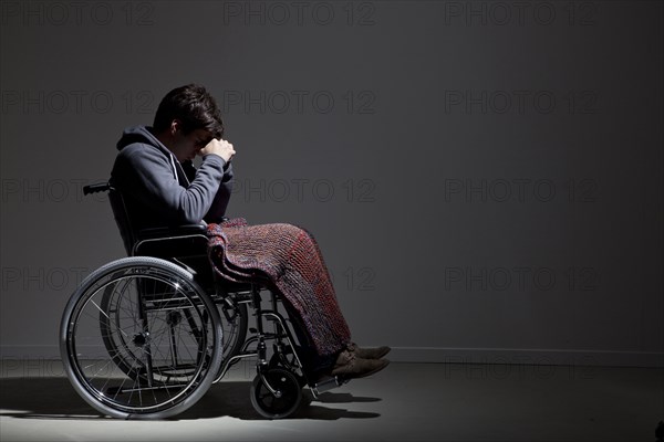 Frustrated Caucasian man in wheelchair