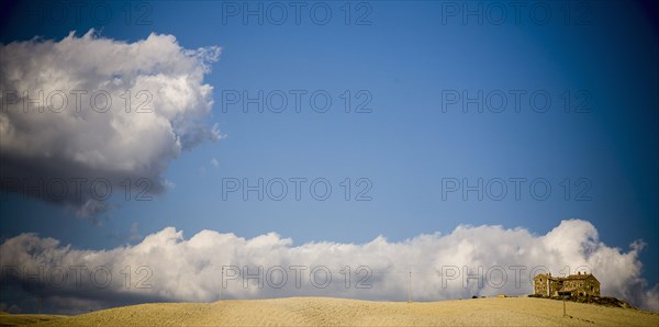 Clouds rolling over estate in rural landscape