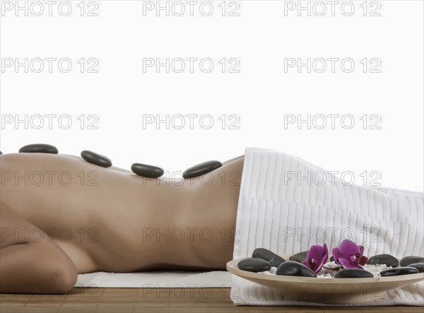 Caucasian woman enjoying hot stone massage