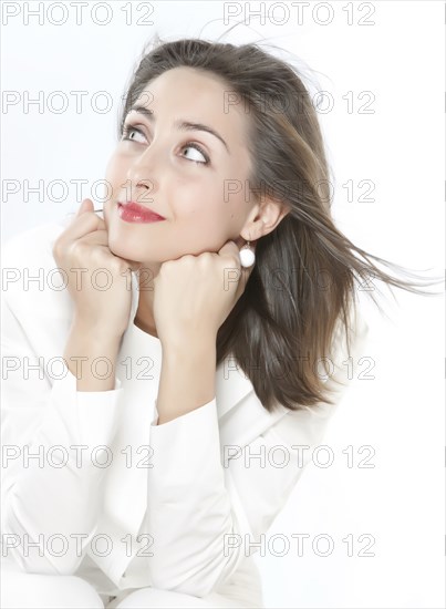 Smiling woman resting chin on hands