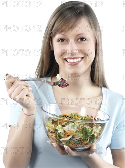 Hispanic woman eating salad