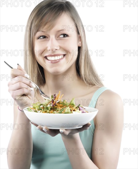 Hispanic woman eating salad