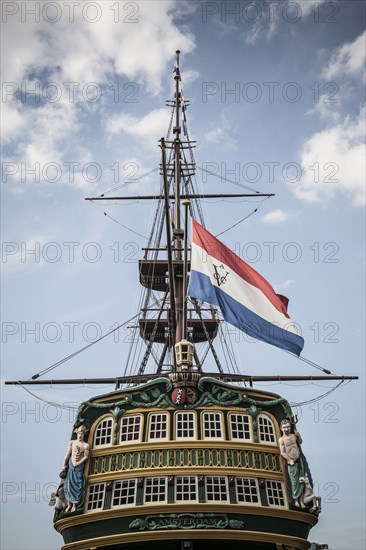Flag flying from pirate ship against blue sky