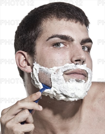 Caucasian man shaving his beard