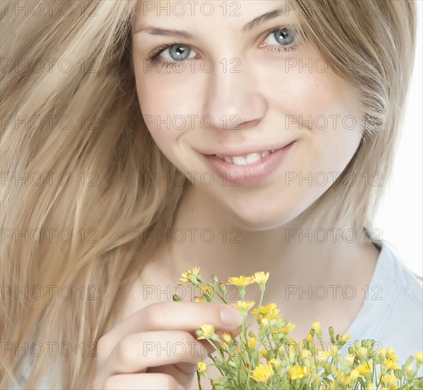 Smiling woman holding bouquet of flowers