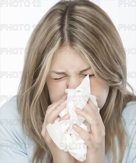 Woman blowing her nose