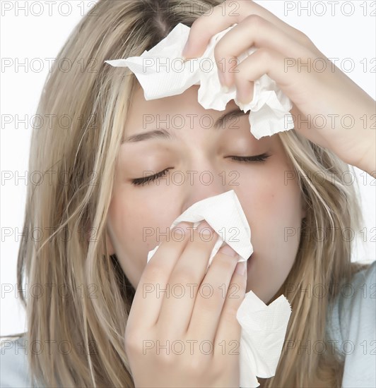 Woman wiping her nose with tissue