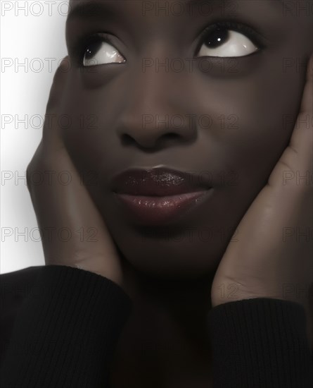 Close up of woman holding her face