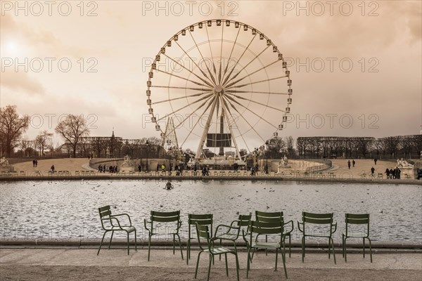 Tourists walking near ferris wheel