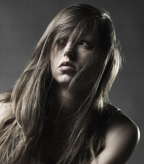 Caucasian woman with long hair looking away