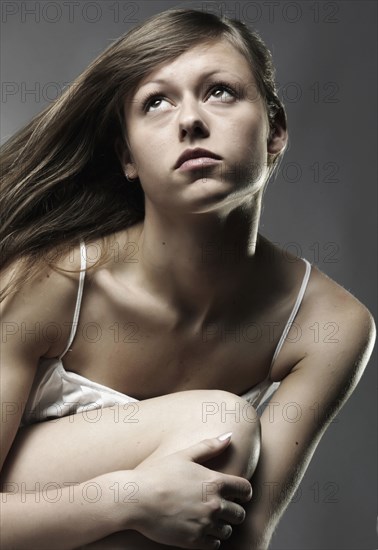 Wind blowing long hair of Caucasian woman