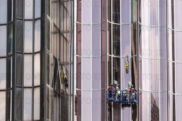 Men washing windows on skyscraper