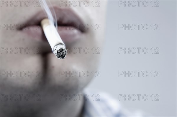 Caucasian man smoking cigarette