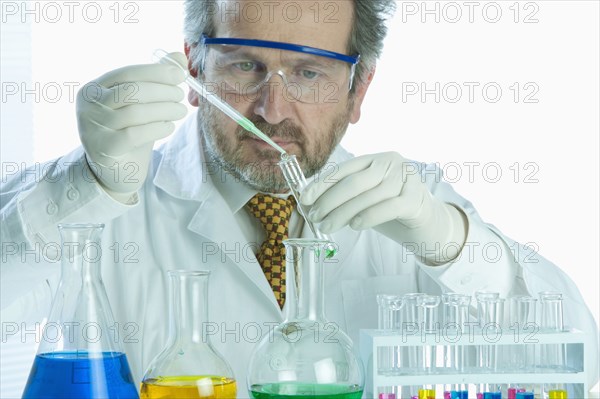 Caucasian scientist mixing liquid in laboratory