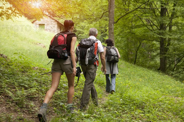 Caucasian man and women hiking on hill