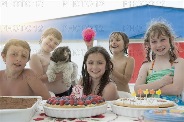 Smiling Caucasian children posing at birthday party