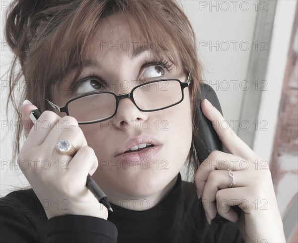 Caucasian businesswoman talking on telephone