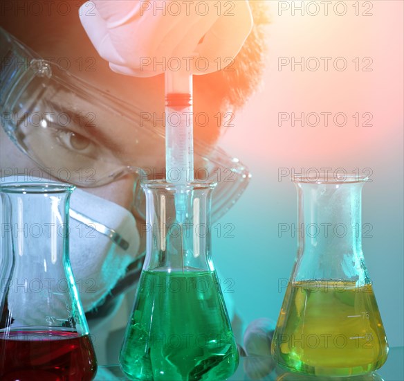 Caucasian scientist experimenting with multicolor liquids