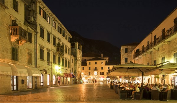 People at outdoor restaurant at night