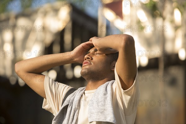 Mixed Race man with headache outdoors