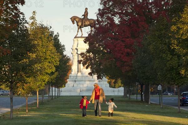 Father and daughters walking in park