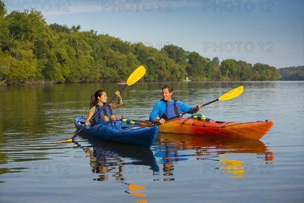 Couple kayaking in river