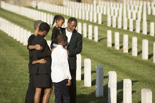 Multi-generation Black family at military cemetery