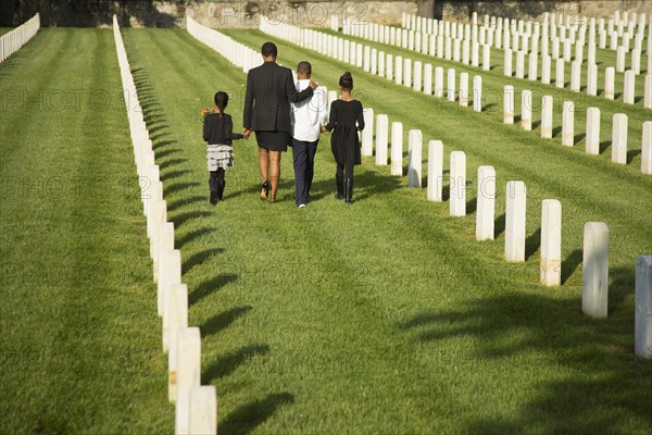 Black family walking in military cemetery