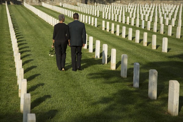 Black couple walking in military cemetery