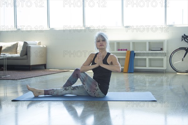 Woman doing yoga with hands clasped