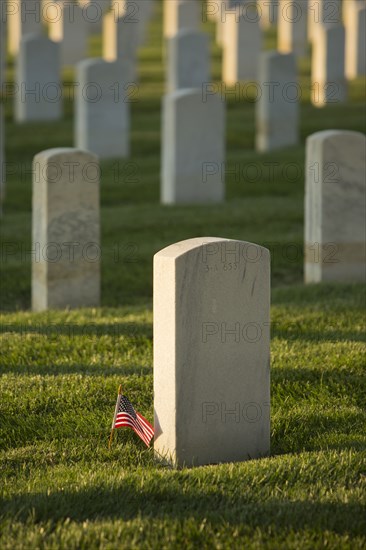 American flag at cemetery gravestone