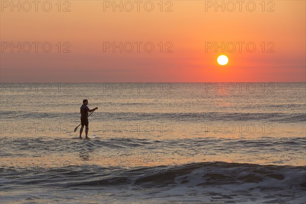 Silhouette of man on ocean