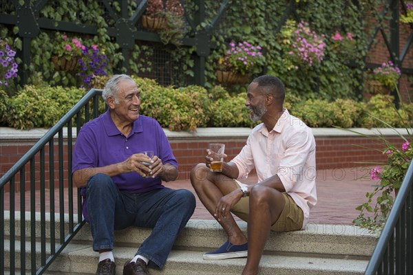 Friends drinking beer in flower garden