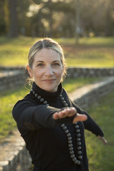 Portrait of Caucasian woman practicing yoga in park