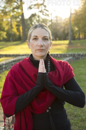 Portrait of Caucasian woman meditating in park