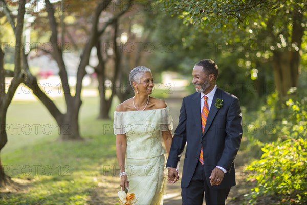 Black couple walking on path in park